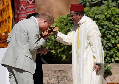 Britain's Prince Harry smells a cedar wood box as he and Meghan, Duchess of Sussex visit to a Social Entrepreneurs event and market in Rabat in Morocco, Monday, Feb. 25, 2019. The Duke and Duchess of Sussex are on a three day visit to the country. (AP Photo/Kirsty Wigglesworth)