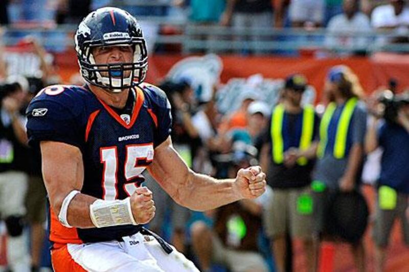 Tim Tebow, the Denver Broncos’ quarterback, celebrates after running the ball in for a two-point conversion against the Miami Dolphins.