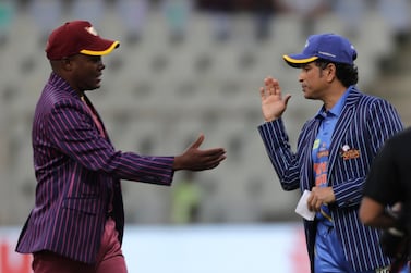 West Indies Legends' Brian Lara and India Legends' Sachin Tendulkar greet each other during a toss ahead of the start of the Road Safety World Series cricket match in Mumbai, India, Saturday, March 7, 2020. (AP Photo/Rajanish Kakade)