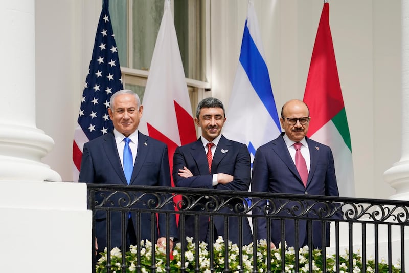 Sheikh Abdullah bin Zayed, UAE Minister of Foreign Affairs and International Co-operation, Israeli Prime Minister Benjamin Netanyahu, left, and Bahraini Foreign Minister Abdullatif Al Zayani stand on the Blue Room Balcony during the signing ceremony. AP