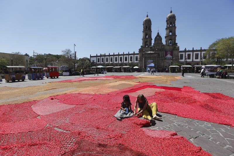 Activists set up a work of art made from red fabric, titled 'Blood of My Blood', made to bring attention to the killing of women, in the main square of Zapopan, Mexico.   EPA