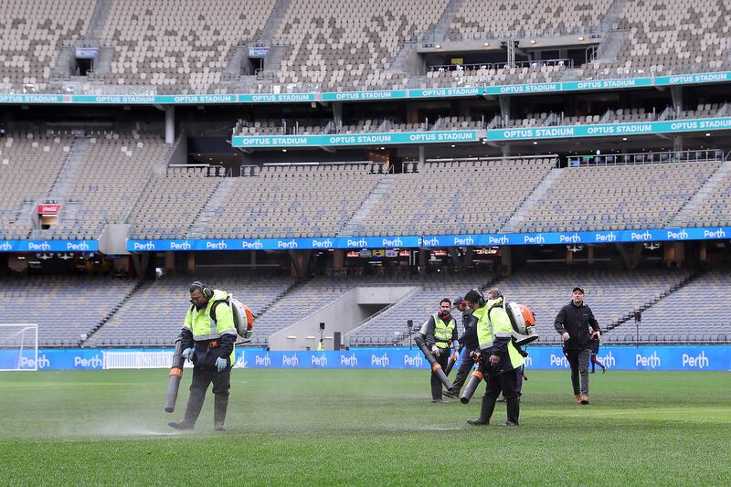 PERTH, AUSTRALIA - JULY 23: Ground staff attempt to dry the water logged pitch before the Pre-Season Friendly match between Manchester United and Aston Villa at Optus Stadium on July 23, 2022 in Perth, Australia. (Photo by Will Russell / Getty Images)