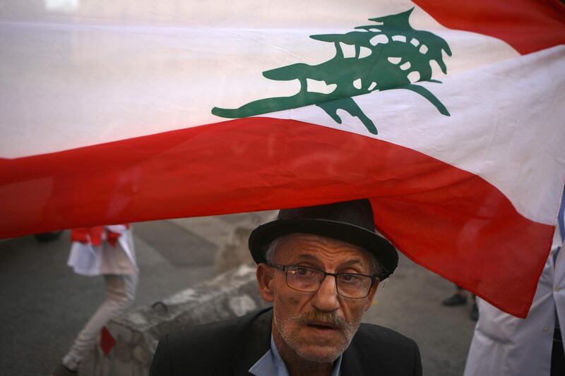 A Lebanese elderly man takes part in ongoing anti-government demonstrations in central Beirut on November 12, 2019. AFP