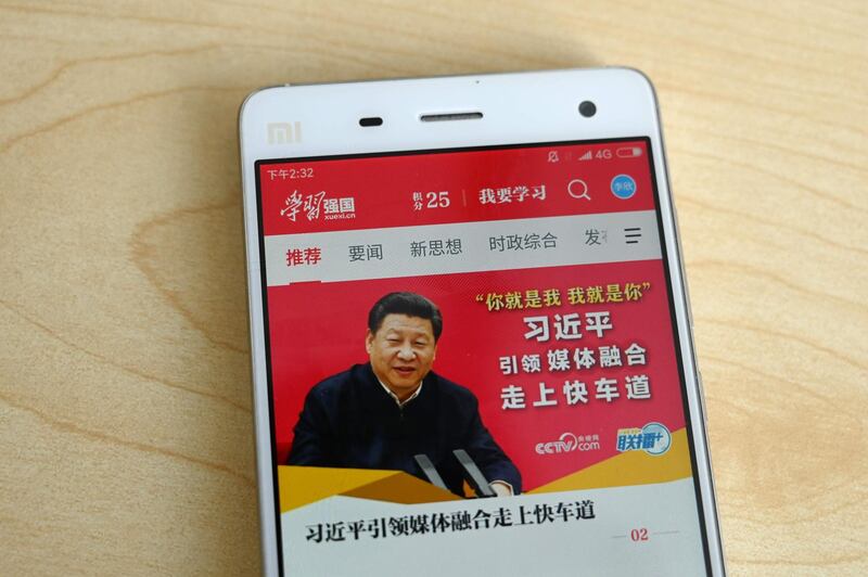 This photo illustratration taken on February 20, 2019 shows a phone app called "Xuexi Qiangguo" or "Study to make China strong" with an image of China's President Xi Jinping in Beijing. A propaganda app that puts China's powerful President Xi Jinping in anyone's pockets has become a hit in the country -- with a helpful nudge from Communist Party officials. Xi, who could rule indefinitely after parliament lifted presidential term limits last year, has enjoyed a level of officially stoked adulation unseen since Communist China's founder Mao.  - TO GO WITH China-politics-internet, FOCUS by Poornima WEERASEKARA
 / AFP / Greg Baker / TO GO WITH China-politics-internet, FOCUS by Poornima WEERASEKARA
