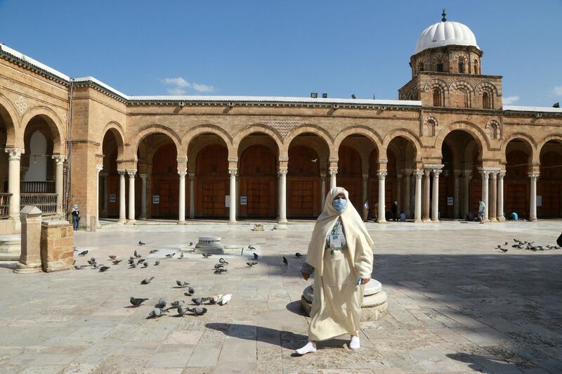 A Tunisian woman walks in the court of Al-Zaytuna mosque, the oldest in Tunis.  AFP
