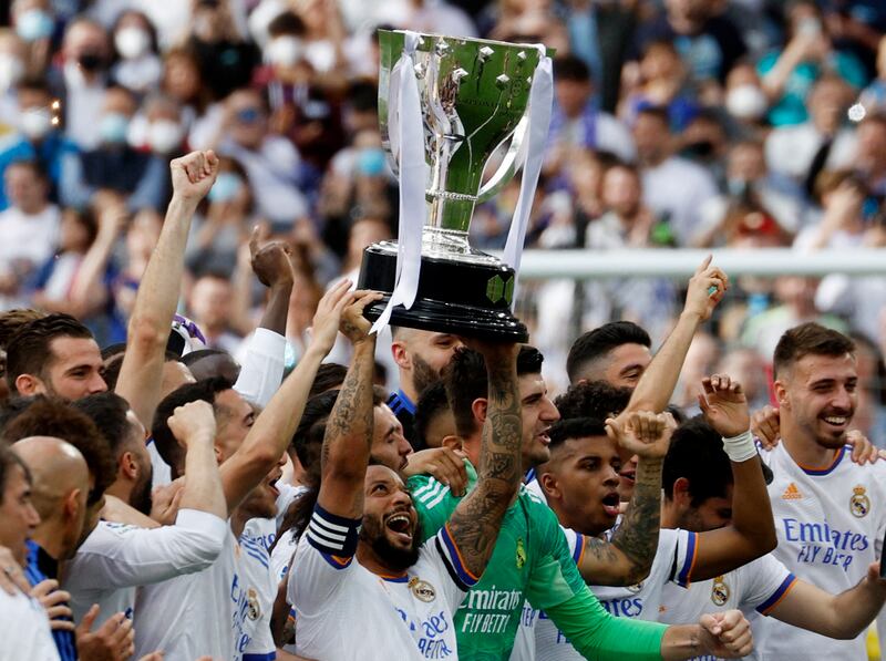 Real Madrid's Marcelo holds the trophy. Reuters