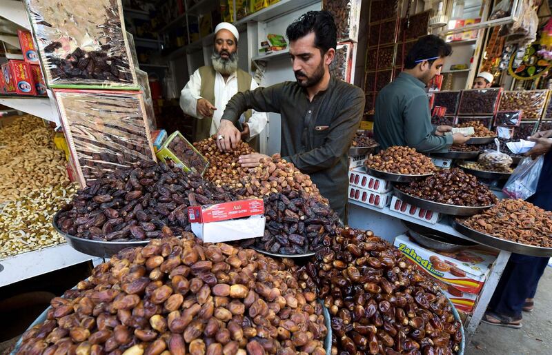 Pakistani vendors sell dates at their shops in Peshawar ahead of the start of the holy fasting month of Ramadan.  AFP