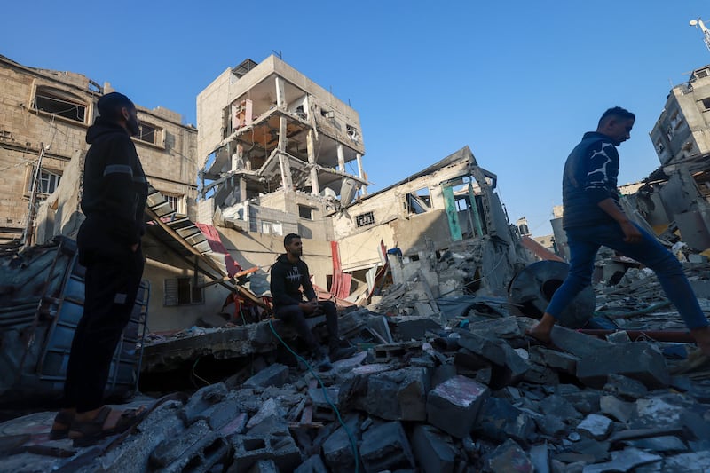 Palestinians inspect a building damaged during Israeli bombardment in Rafah. AFP