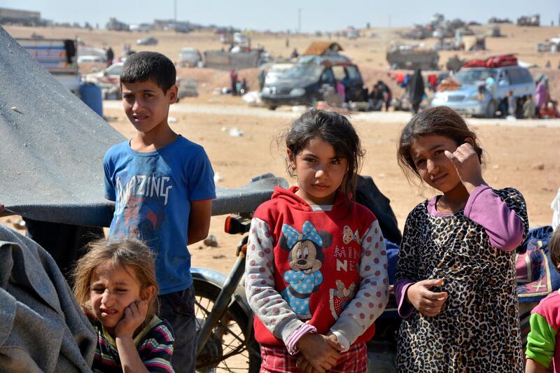 epa06261924 Displaced Syrian children who fled from Deir Ezzor and al-Raqqa cities occupied by Islamic State (IS) group fighters, gather in Qana refugee camp, southern Hassakeh province, 11 October 2017 (Issued 12 October 2017). The flow of displaced Syrians from the governorates of Deir Ezzor and al-Raqqa continues to Qana camp south of al-Hassakah city, to escape the fighting between the Islamic state organization and the fighting forces. The number of displaced people reached 27 thousand, while the capacity of the camp is 12 thousand, which let for the camp to stop receiving refugees for four days.  EPA/YOUSSEF RABIH YOUSSEF