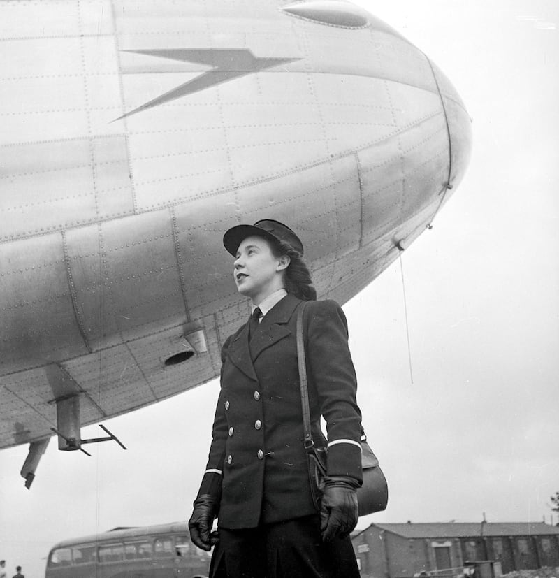 April 1946:  Miss B Midgley of Northolt aerodrome stands under the nose of a BOAC (British Overseas Airways Corporation) aircraft. She is one of ten 'air traffic girls' currently taking part in a course at Hurn airport, to learn how to deal professionally with passengers.  (Photo by George Konig/Keystone Features/Getty Images)