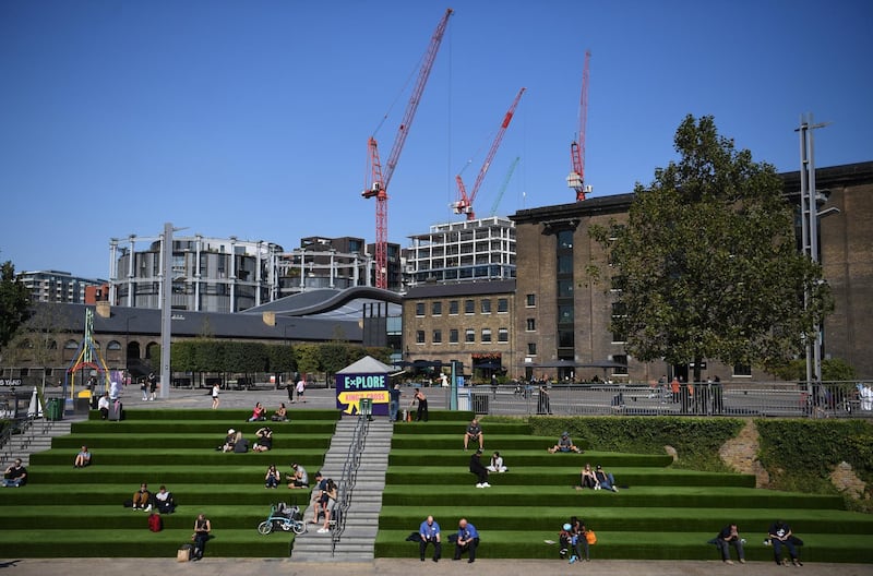 People sit in the sunshine in Kings Cross in London, Britain. EPA