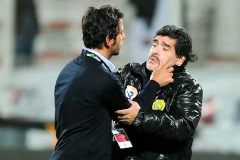 Quique Sanches Flores, and Diego Maradona argue following the Etisalat Cup semi-final in March 2013. Courtesy of Al Ittihad