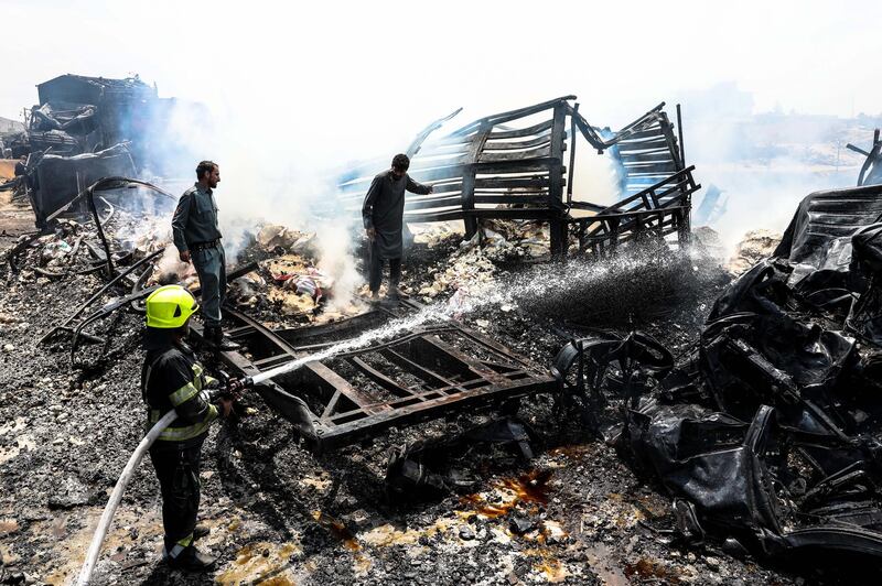 Firefighters work to extinguish burning fuel tankers a day after dozens of logistic trucks, mostly petrol tankers, have burned in flames in the outskirt of Kabul. EPA