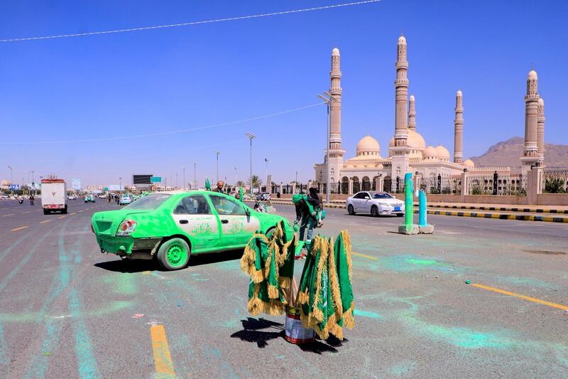 A Yemeni man spray paints a truck green, a color that holds religious significance in Islam, in front of Al-Saleh mosque in the capital Sanaa in response to comments by French President Emmanuel Macron defending cartoons of the Prophet Mohammed. AFP