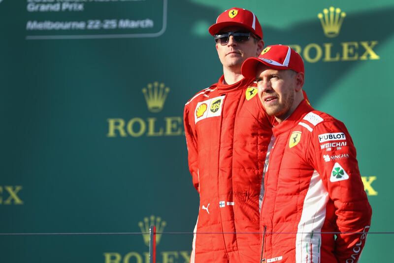 MELBOURNE, AUSTRALIA - MARCH 25: Race winner Sebastian Vettel of Germany and Ferrari and third placed Kimi Raikkonen of Finland and Ferrari on the podium  during the Australian Formula One Grand Prix at Albert Park on March 25, 2018 in Melbourne, Australia.  (Photo by Mark Thompson/Getty Images)