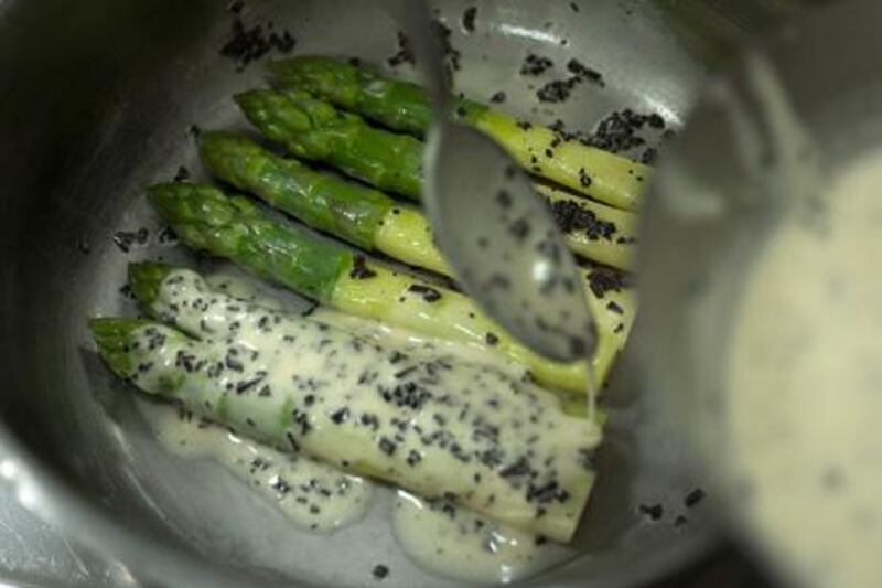 5. Put the asparagus in a clean saucepan, spoon over the butter sauce and place on the stove to warm through. Turn the asparagus over to coat it with sauce on both sides.