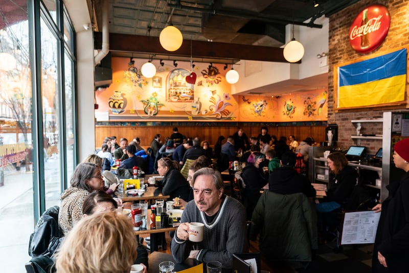 People dine inside Veselka restaurant where a Ukrainian flag hangs in the East Village in New York. AP