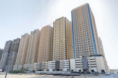 AJMAN, UNITED ARAB EMIRATES. 16 MAY 2019. Four years after they moved in, residents and apartment owners at Paradise Lake Towers are still waiting for their internet connection to be installed. The buildings are still also not connected to the electrical grid and several apartments face severe construction quality issues. Exteriors of the affected buildings. (Photo: Antonie Robertson/The National) Journalist: Ruba Haza. Section: National.