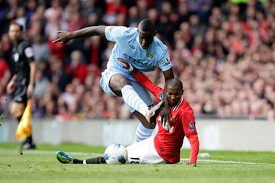 Micah Richards barrels past Manchester United’s Ashley Young.