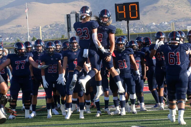 Herriman players celebrate as they take the field against Davis for a high school football game in Herriman, Utah. Utah is among the states going forward with school sport despite concerns about the ongoing coronavirus pandemic. AP Photo