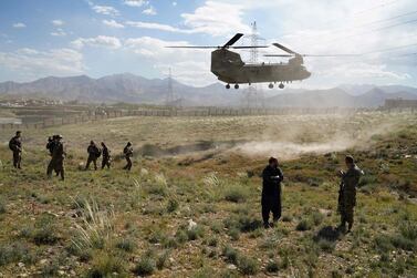 A US military Chinook helicopter lands on a field outside the governor's palace during a visit by the commander of US and NATO forces in Afghanistan, General Scott Miller, and Asadullah Khalid, acting minister of defence of Afghanistan, in Maidan Shar, capital of Wardak province. AFP