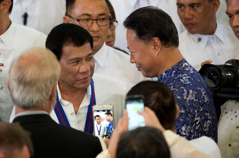 Philippine president Rodrigo Duterte (L) – pictured here with Chinese ambassador to the Philippines Zhao Jianhua (R) on August 17, 2016 – denies being a drug addict. Noel Celis/Pool/File Photo/Reuters