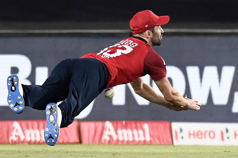 England's Mark Wood drops a chance off India batsman Rohit Sharma. AFP