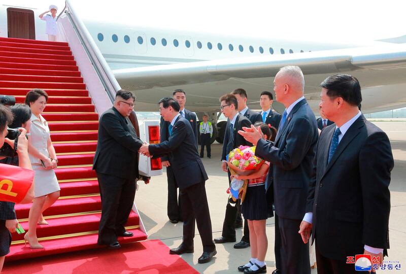 The North Korean leader was greeted by Wang Huning, member of the Politburo Standing Committee, on arrival at Beijing Capital International Airport in Beijing. KCNA / AP Photo