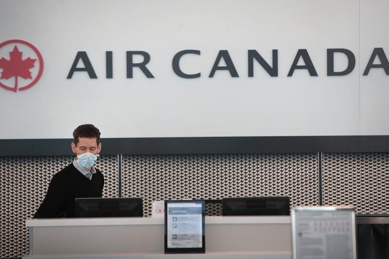CHICAGO, ILLINOIS - APRIL 02: An Air Canada worker waits for travelers at a nearly-empty O'Hare International Airport on April 2, 2020 in Chicago, Illinois. The airport, which typically serves 8.2 million passengers a month, has closed two of its seven runways as the COVID-19 pandemic has significantly reduced air travel.   Scott Olson/Getty Images/AFP
== FOR NEWSPAPERS, INTERNET, TELCOS & TELEVISION USE ONLY ==
