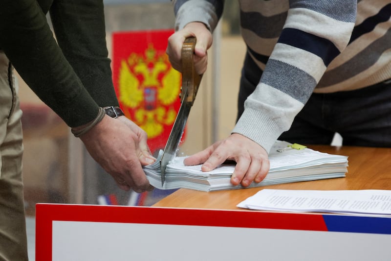 Electoral commission members destroy unused ballot papers in St Petersburg. Reuters