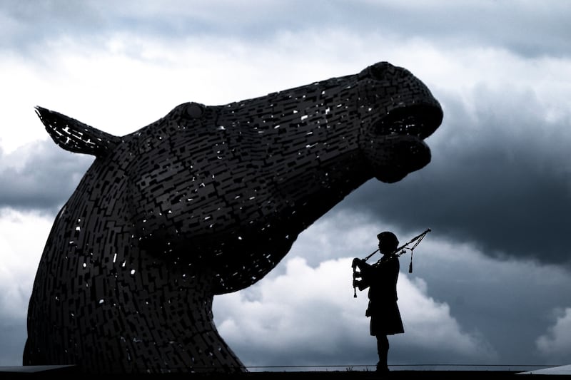 A piper plays during a special event to celebrate the 10th anniversary of the Kelpies sculpture in Falkirk, central Scotland. PA