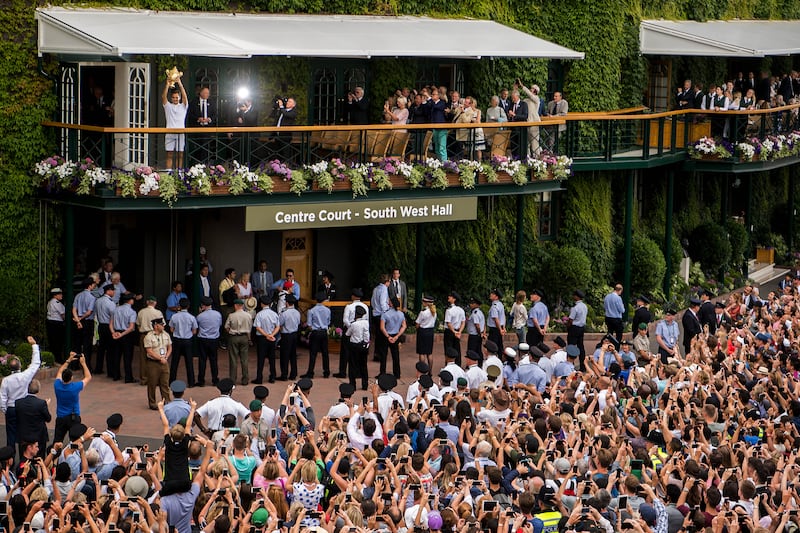 Spectators applaud and take photographs as Switzerland's Roger Federer celebrates his record eighth Wimbledon men's singles title on the balcony of Centre Court in 2017.
