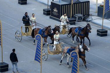 Costumed men ride on horse-drawn Pharaonic War Wheels before a parade to transfer 22 ancient Egyptian royal mummies to the National Museum of Egyptian Civilization, in Cairo. EPA