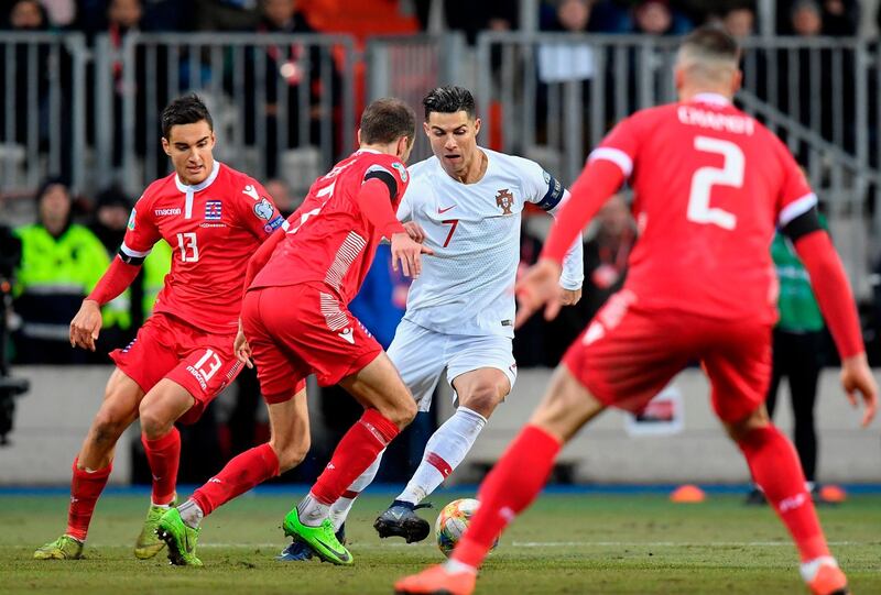 Luxembourg defender Dirk Carlson vies with Portugal forward Cristiano Ronaldo. AFP