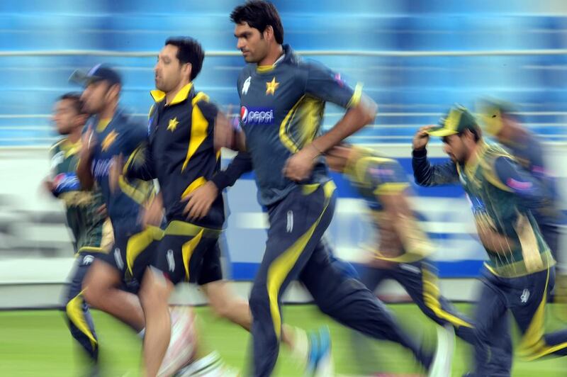 Pakistani Twenty20 cricketers warm up during a net session at Dubai International Cricket Stadium in Dubai on December 3, 2014.. Aamir Qureshi / AFP
