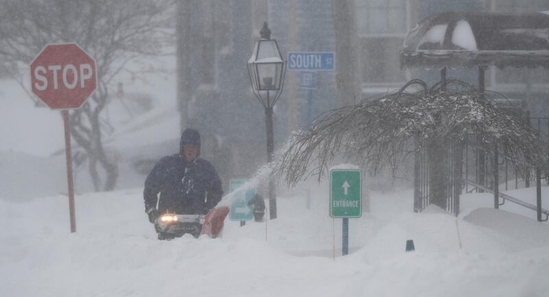 A man uses a snowblower to clearsnow from a pavement in Foxborough, Massachusetts.Matt Campbell / EPA