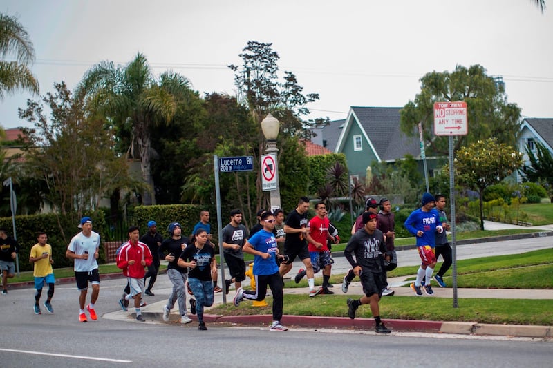 Manny Pacquiao (2ndR) jogs in the morning with fans and friends in Los Angeles. AFP