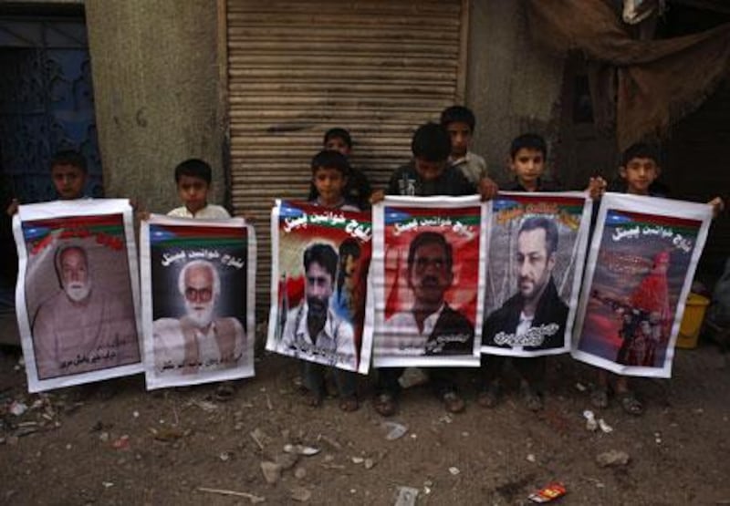 Baloch children hold up nationalist posters.