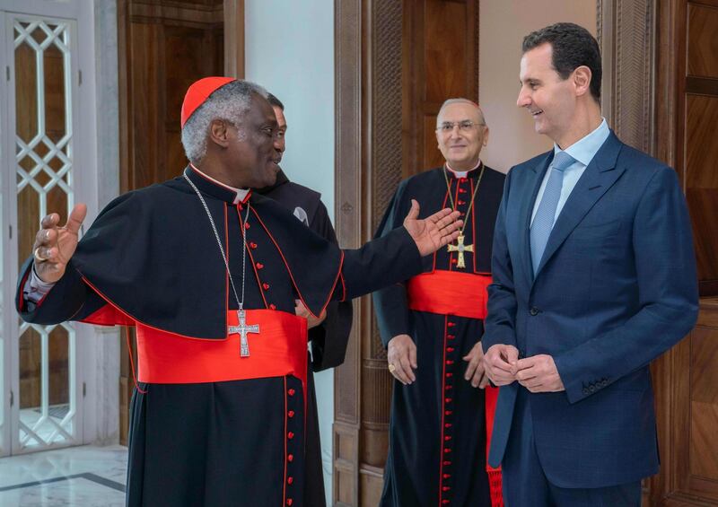 This handout picture released by the official Syrian Arab News Agency (SANA) shows Syrian President Bashar al-Assad (R) listening to Cardinal Peter Kodwo Appiah Turkson (L) during a visit by a delegation from the Vatican to the Syrian capital Damascus on July 22, 2019. The delegation handed Assad a letter from Pope Francis, "who expressed (his) deep concern for the humanitarian situation in Syria, especially the dramatic conditions of the civilian population in Idlib," according to a Vatican statement.  -  == RESTRICTED TO EDITORIAL USE - MANDATORY CREDIT "AFP PHOTO / HO / SANA" - NO MARKETING NO ADVERTISING CAMPAIGNS - DISTRIBUTED AS A SERVICE TO CLIENTS ==
 / AFP / SANA / STRINGER /  == RESTRICTED TO EDITORIAL USE - MANDATORY CREDIT "AFP PHOTO / HO / SANA" - NO MARKETING NO ADVERTISING CAMPAIGNS - DISTRIBUTED AS A SERVICE TO CLIENTS ==
