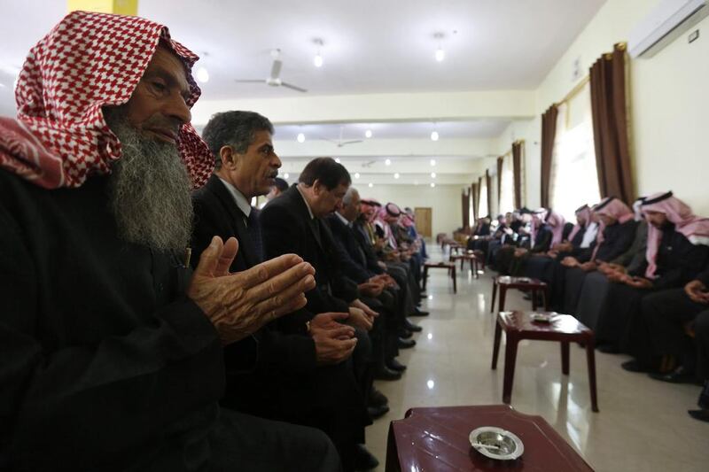 Relatives of Jordanian pilot Muath al-Kasaesbeh pray at the family’s clan headquarters in the city of Karak on February 4, 2015. Muhammad Hamed/Reuters