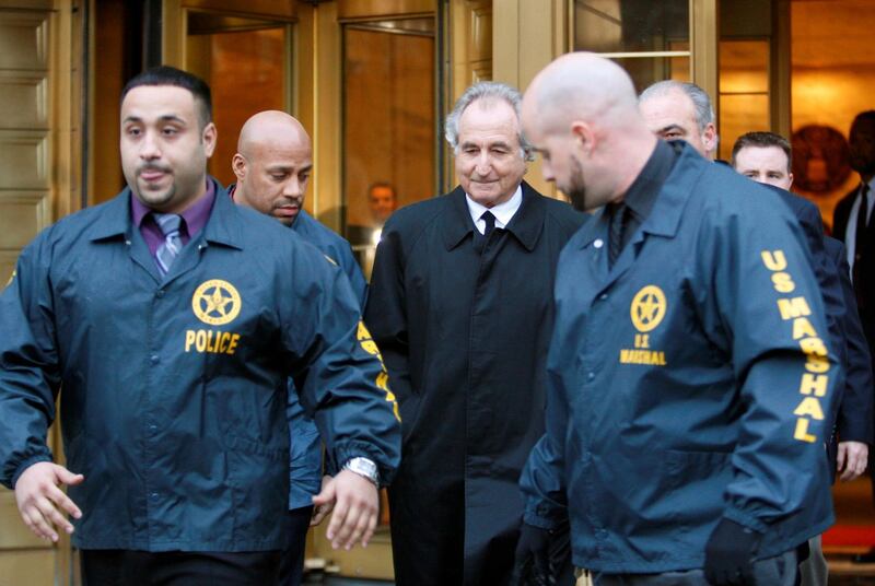 Disgraced financier Bernard Madoff, centre, leaves the US District Court in Manhattan escorted by US Marshals after a bail hearing in New York on January 5, 2009. AP
