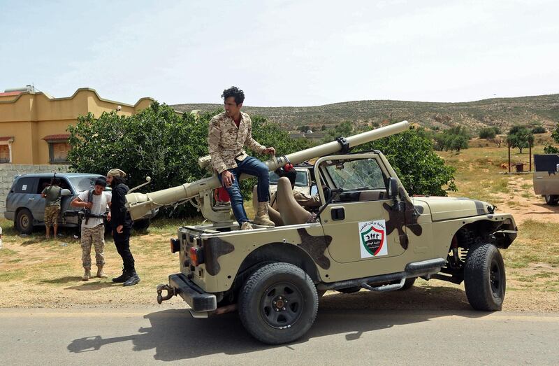 Fighters with Libya's UN-recognised Government of National Accord (GNA) gather at a position near the town of Garabulli, some 70 kms east of the capital Tripoli, as they engage in battles with forces loyal to the Libyan strongman Khalifa Haftar, on April 19, 2020.   / AFP / Mahmud TURKIA
