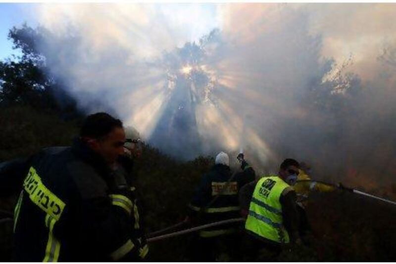 Israeli firefighters try to extinguish fire in the Carmel Forest near the northern city of Haifa as emergency teams, aircraft and equipment streamed in from other countries.
Omer Messinger / AFP