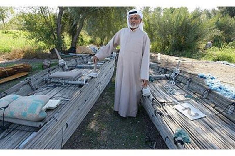 Abdullah Mohammed, a boat builder, with the shashas at his farm in Al Owaid.