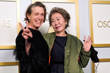 Frances McDormand, winner of Best Actress, and Youn Yuh-jung, winner of Best Actress in a Supporting Role, pose in the press room at the Oscars. Reuters