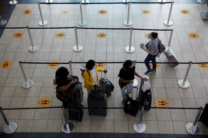 Travelers line up to check-in at the Tocumen International Airport, Panama. Tocumen International Airport, the main one in Panama and a regional hub, began limited commercial flight operations this Friday after almost five months of closure due to the COVID-19 pandemic.  EPA