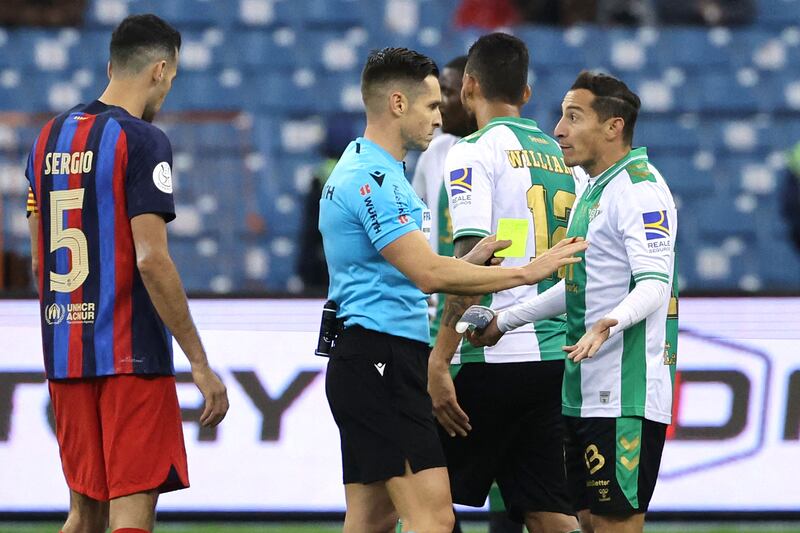 Real Betis midfielder Andres Guardado (r) remonstrates with Spanish referee Carlos de Cerro Grande after receiving a second yellow card. AFP