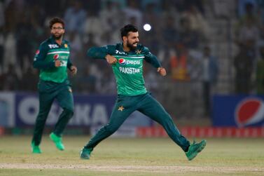 Pakistan's Shadab Khan, center, celebrates after taking the wicket of West Indies' Akeal Hosein during the third one day international cricket match between Pakistan and West Indies at the Multan Cricket Stadium, in Multan, Pakistan, Sunday, June 12, 2022.  (AP Photo / Anjum Naveed)