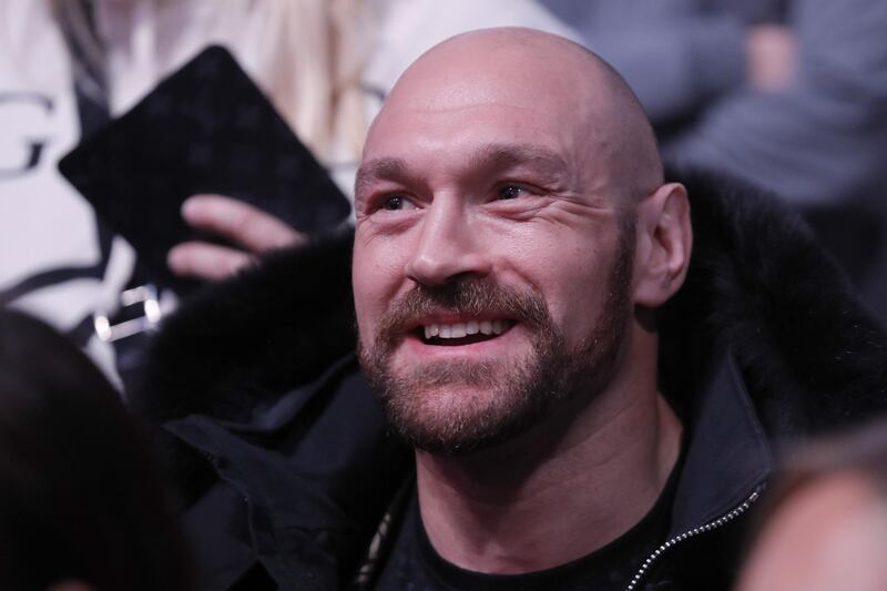 Boxer Tyson Fury watched on from cage side. AFP