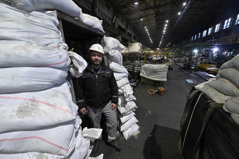 An employee stands next to a shelter at a stainless pipes plant in Nikopol, Dnipropetrovsk region. AFP